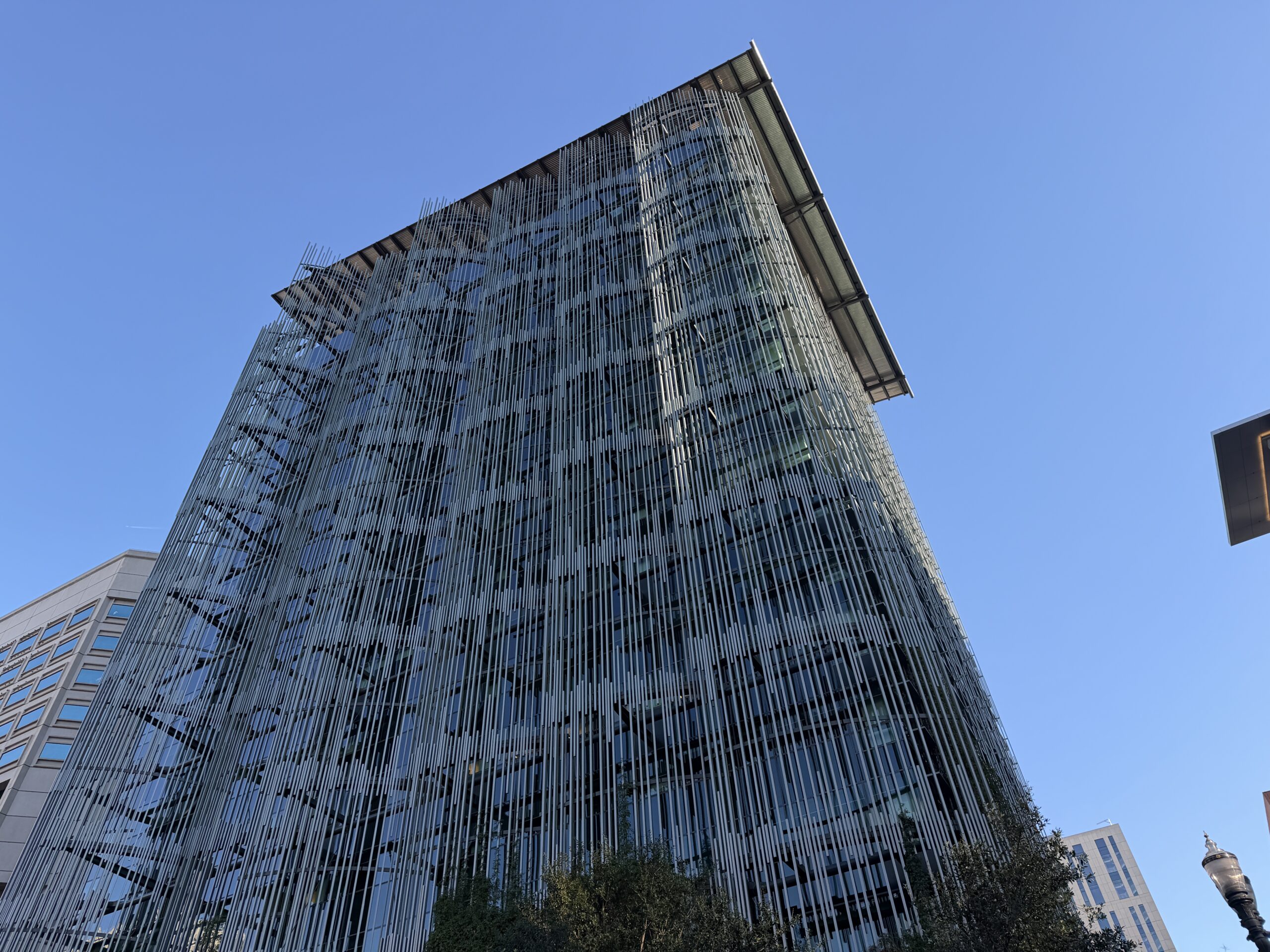 Close-up of a modern building facade incorporating sustainable features like green walls or solar panels, representing ESG.