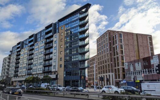 Panoramic view of modern residential buildings set against the London skyline, symbolizing UK property investment.
