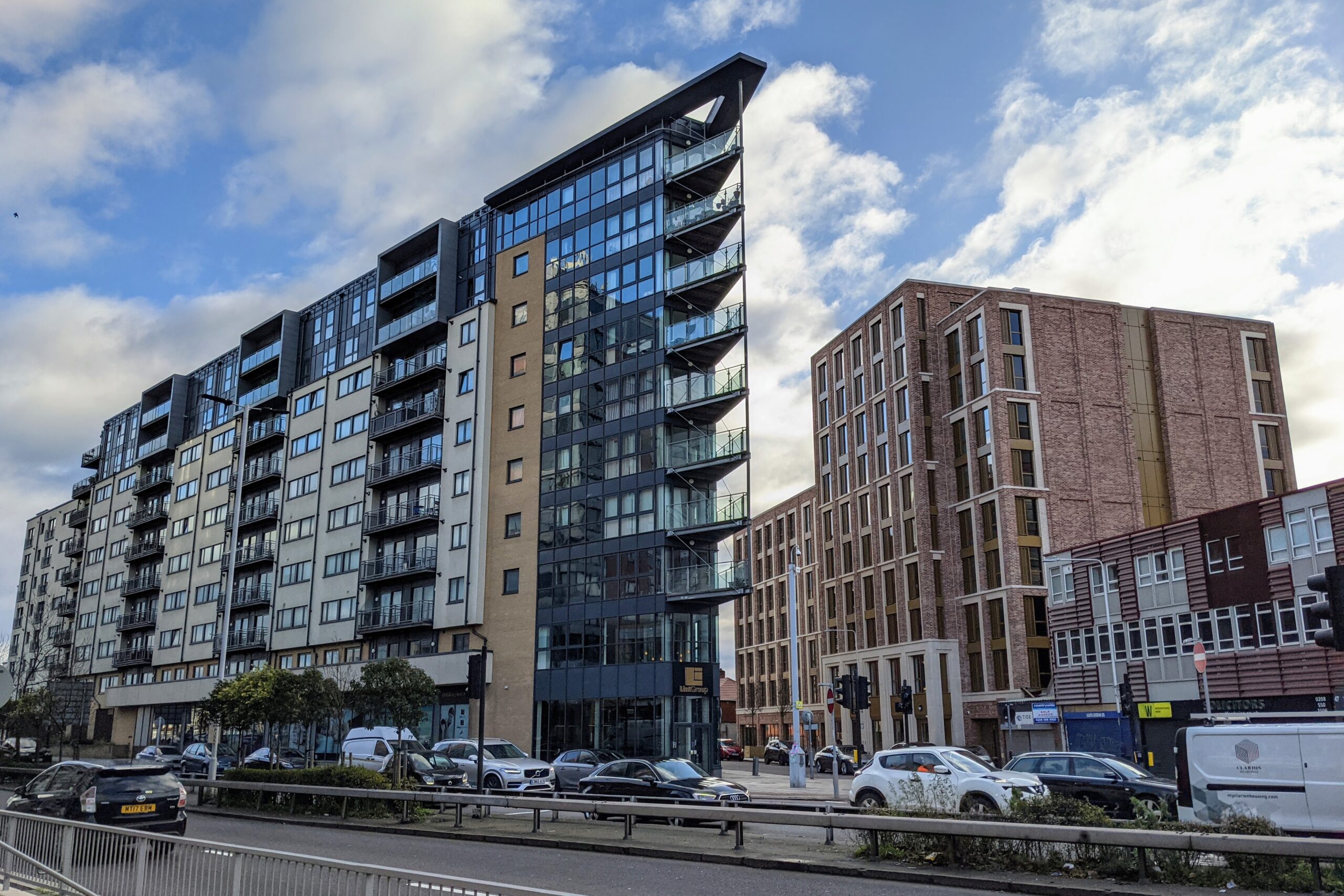 Panoramic view of modern residential buildings set against the London skyline, symbolizing UK property investment.