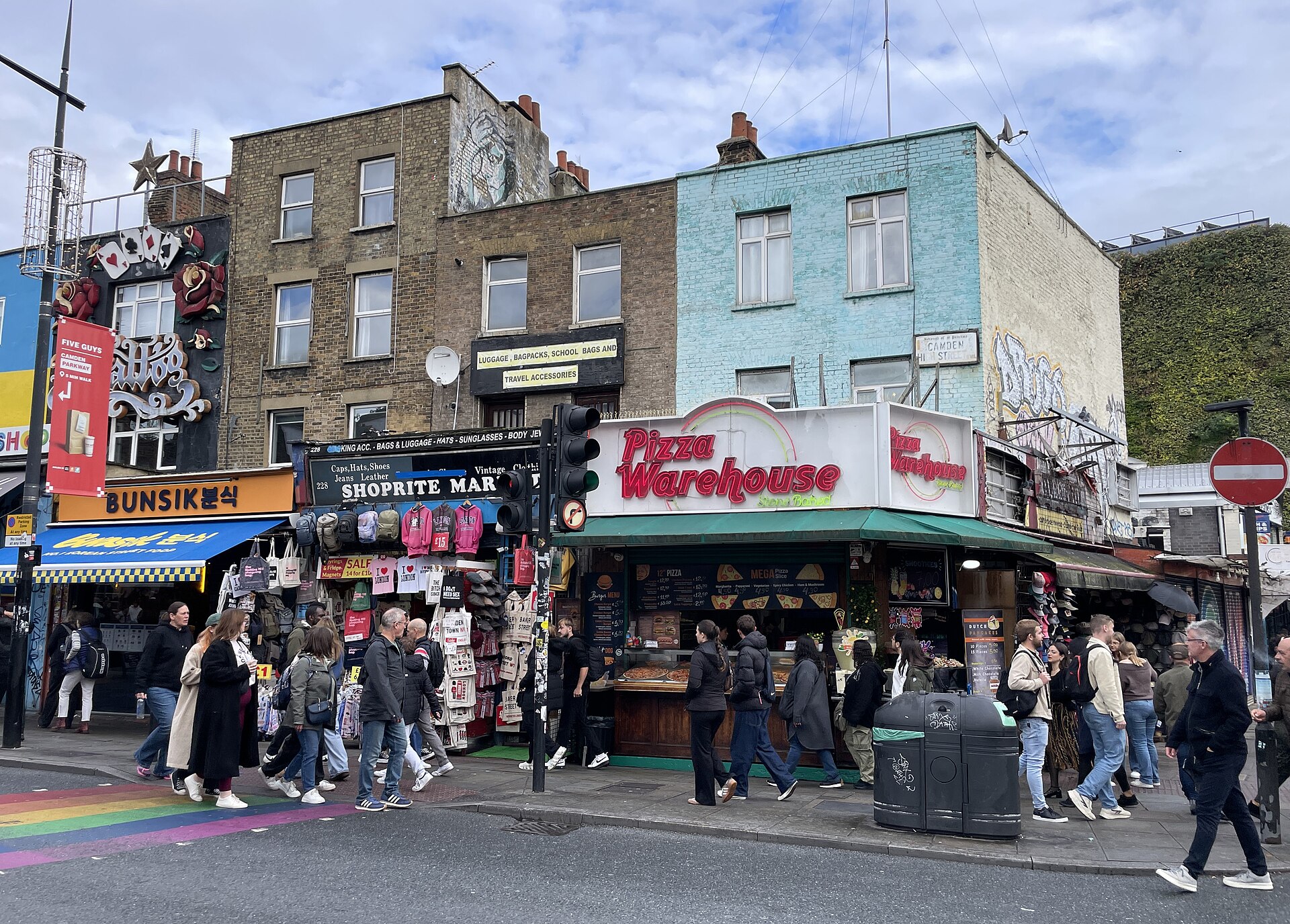 Bustling UK high street with diverse retail shops, pedestrians, and clear signs of commercial activity, illustrating strong rental demand.