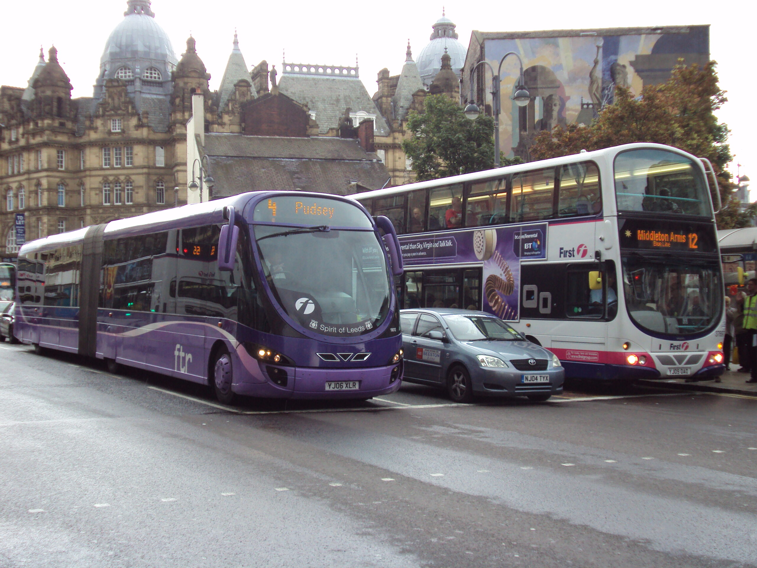 Busy central Leeds street with modern offices, apartments and pedestrians