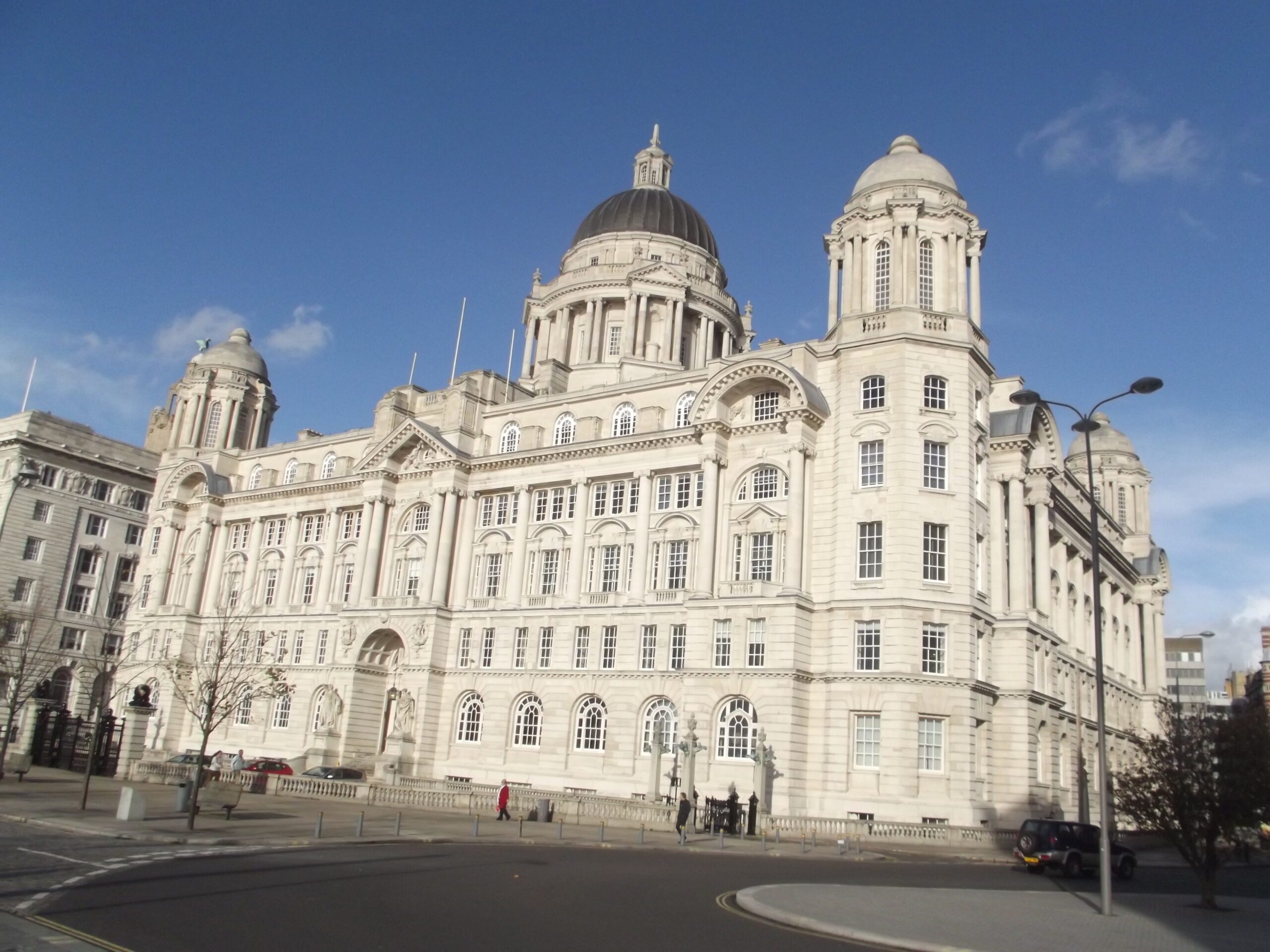Modern apartment buildings near Liverpool waterfront with city activity