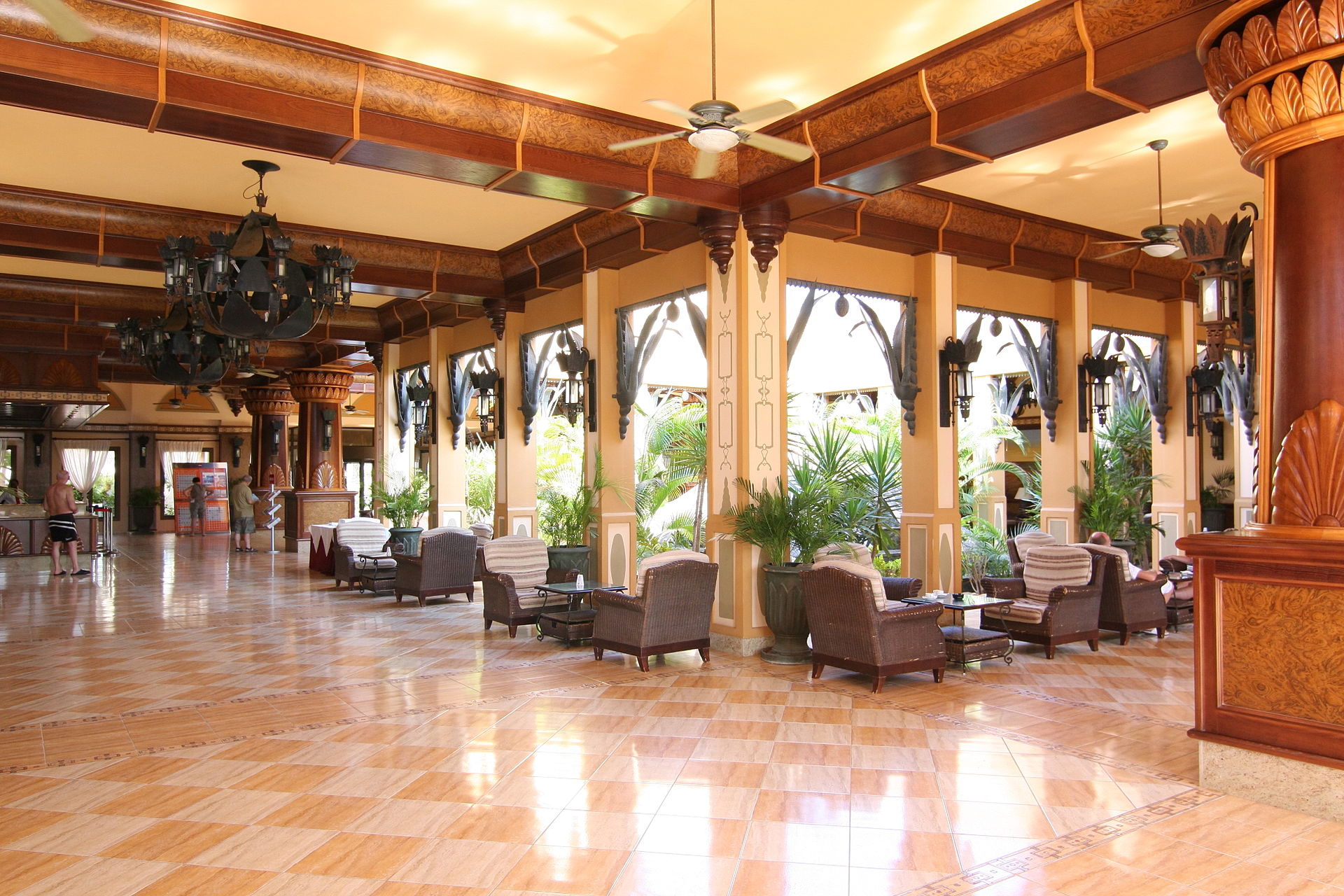 Guests and staff in a polished hotel reception lobby