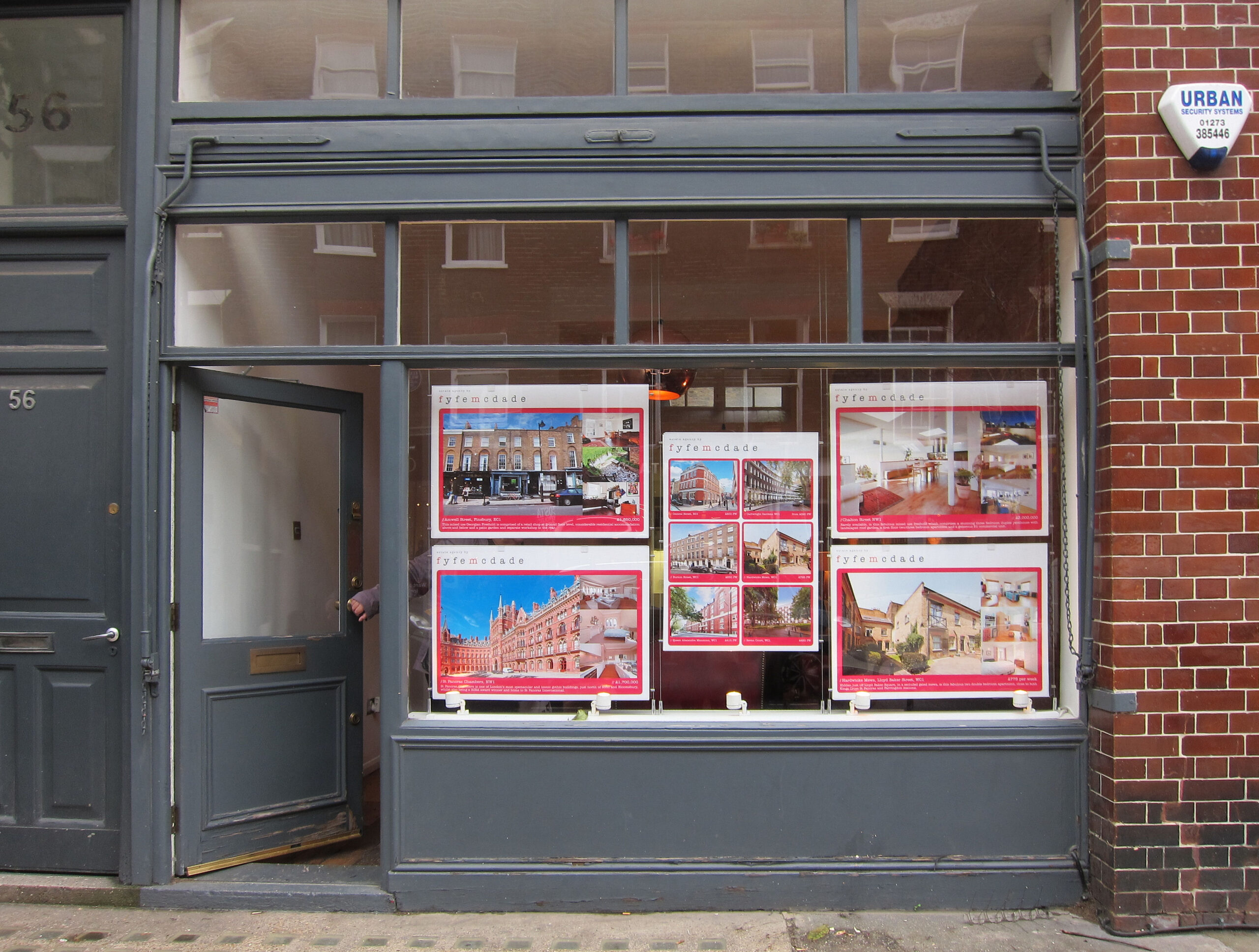 Property listings displayed in a London estate agent window