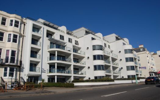 Modern build-to-rent apartment buildings overlooking a UK city skyline